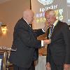 Inductee Kip Becker receives his DAHF medallion from DAHF President Bruce Lambrecht