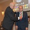Inductee Albert Burk receives his DAHF medallion from DAHF President Bruce Lambrecht