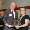 Inductee Rubel Archuleta's daughter Ann accepting plaque in his honor. 