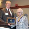 Inductee Doug Harris' wife Ruth accepting plaque in his honor.