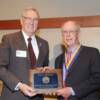 President Van Den Heuvel presenting inductee plaque to USAF Brig.Gen.(Ret) Jon Reynolds.