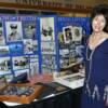 Inductee David McCallister's daughter poses with her father's display.