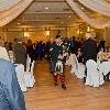 The "Happy Bagpiper" Thom Moore leads the procession.