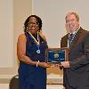 2022 Inductee Scott Alwine is presented his plaque & medallion by VP LeSans Alexander.