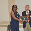 2022 Inductee Larry Kelly is presented his plaque & medallion by DAHF Vice President LeSans Alexander.