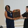 DAHF Vice President LeSans Alexander and Trustee Yeni Ocampo present the Delaware Aviation Hall of Fame Honor plaque that lists all the inductees that are in the Hall of Fame.