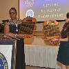 DAHF Vice-President LeSans Alexander & Treasurer Yeni Ocampo show the audience the DAHF Inductees Honor Roll plaques that have the names of every inductee since 2000.